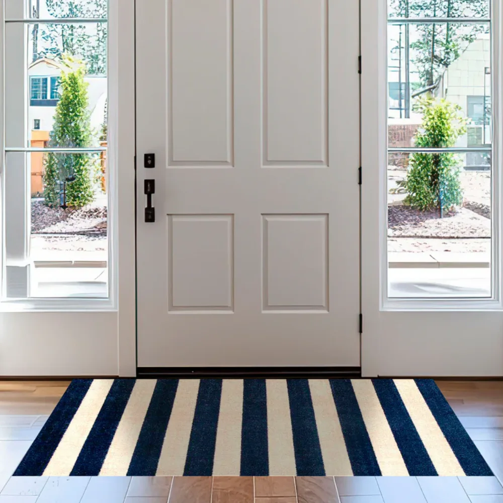 Durable navy blue and white Striped Mats on a sunlit patio deck for a coastal aesthetic.