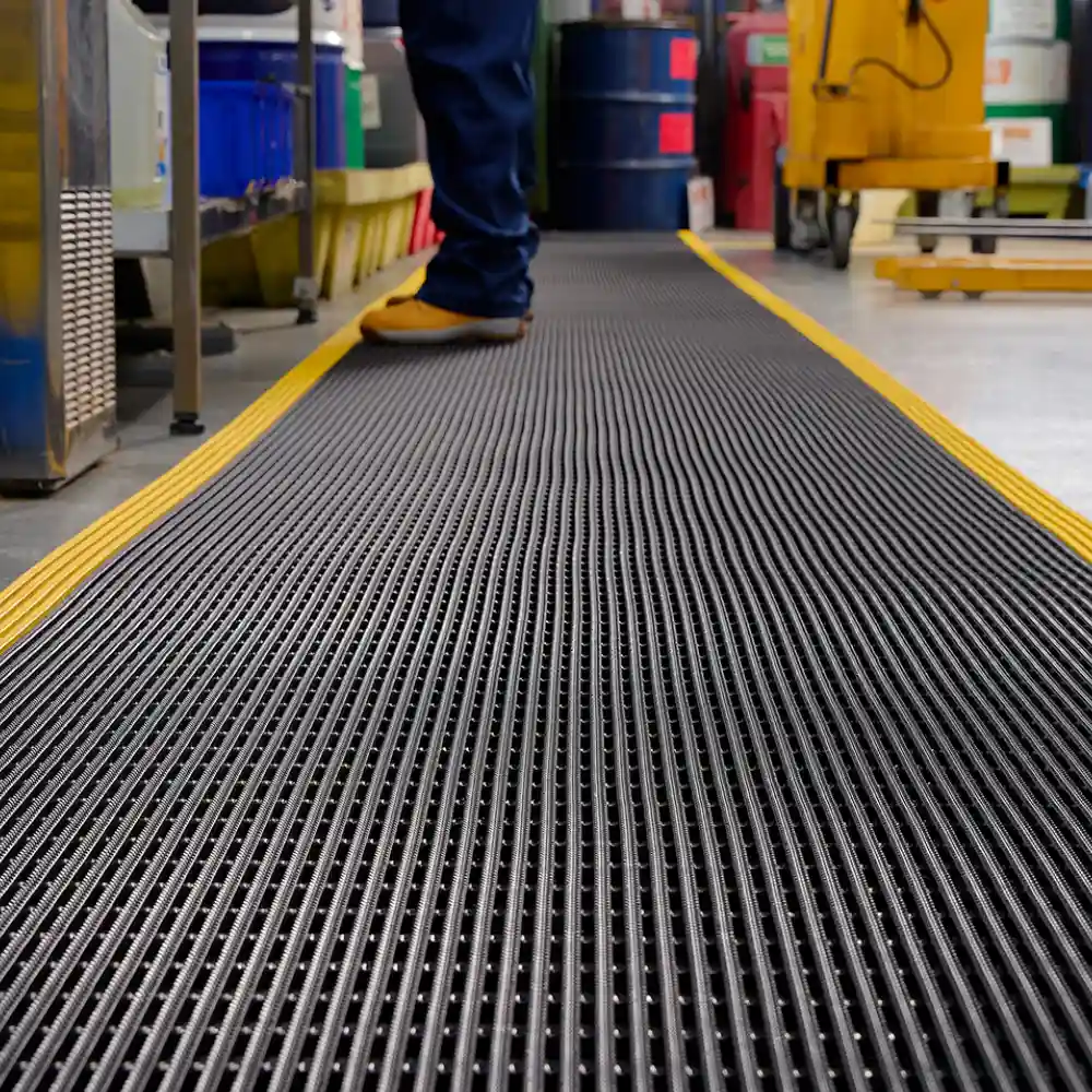 Ergonomic Industrial Mats placed at a factory workstation to reduce worker fatigue.