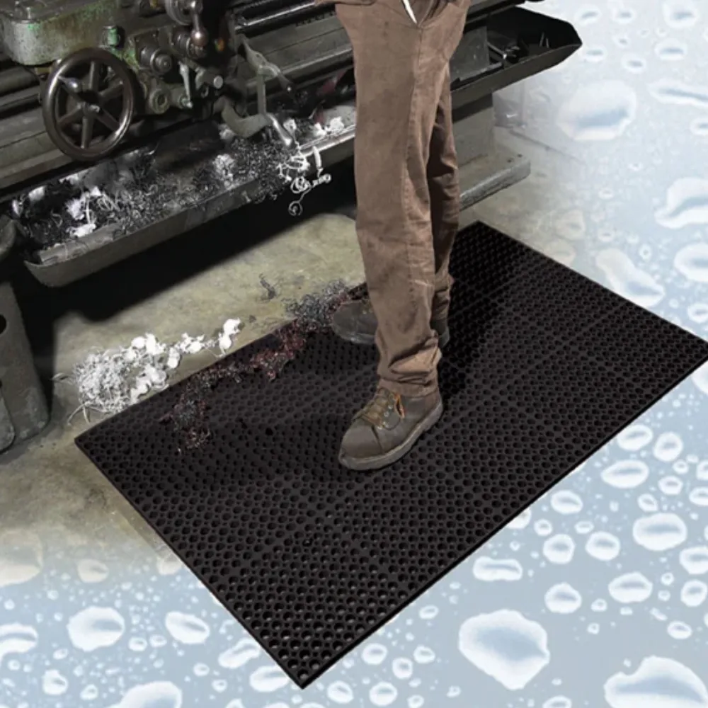 Non-slip Drainage Mats providing a dry, secure walking surface in a wet industrial work area.