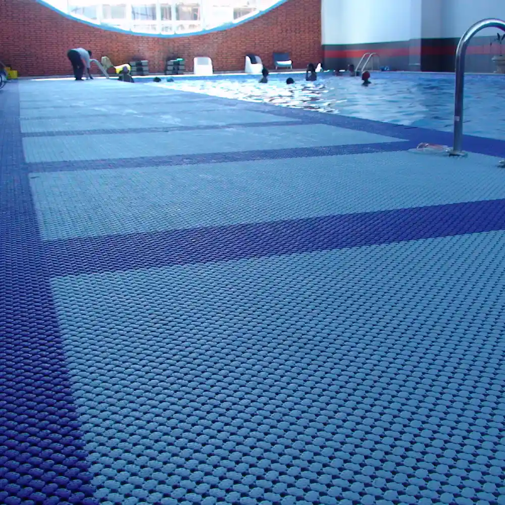 Non-slip blue Swimming Pool Mats placed on a wet deck to prevent falls and ensure safety.