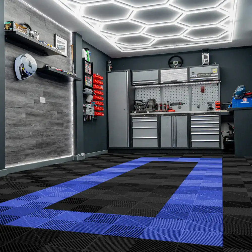 Sleek dark grey Garage Floor Tiles installed under a luxury vehicle in a garage.