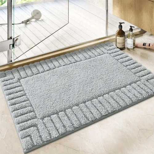 Soft microfiber bath mat with anti-slip backing at a bathroom entrance in a contemporary home